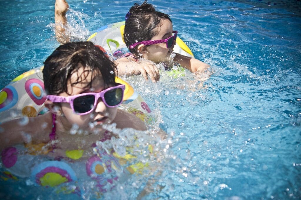 girls, swimming, splashing, sisters, little girls, floaters, swim, swimming pool, pool, summer, vacation, splashing water, childhood, children, kids, shades, sunglasses, people, water, cute, wet, nature, young, happy, joy, fun, activity, happiness